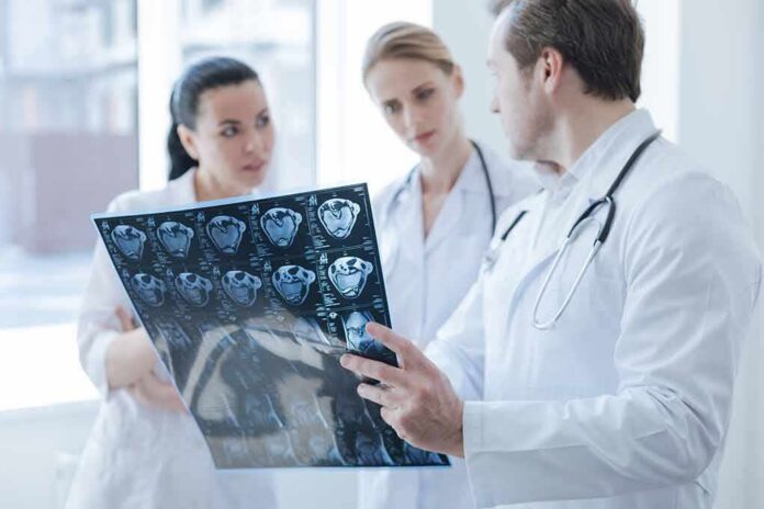 shutterstock_654691387 Doctors reviewing brain scan images together