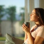 Coffee Rewires Our Memory – But With a Catch! Woman enjoying a cup of coffee in a sunlit room