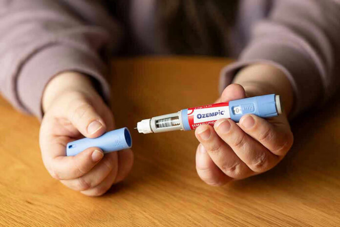 2349255139-1 Hands holding an Ozempic injection pen.