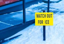 Accident Victim? – Lawyer Up Or Get Steamrolled yellow warning sign in snow near walkway