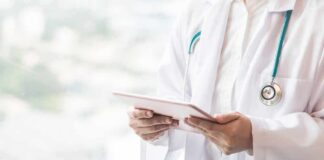 Doctor with stethoscope using a tablet