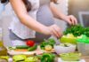 Plant-Based Trap Raises Cancer Risk? Person preparing a fresh salad with green vegetables in a kitchen