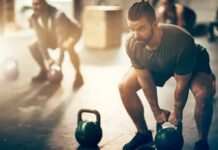 Smell This, Smash More Reps Man lifting a kettlebell in a gym