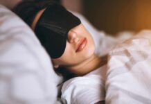 Sleep Debt Trap: Why Weekend Catch-Up Never Works Woman sleeping with a black eye mask in bed