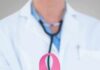 Cancer Screenings Freezing Out Millions Doctor holding stethoscope with pink ribbon in front