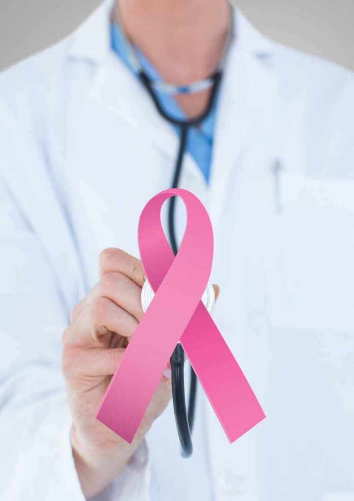 shutterstock_1087739549 Doctor holding stethoscope with pink ribbon in front