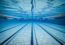 Swimming Vs. Running — Which Is Better For Your Heart? Underwater view of empty swimming pool lanes