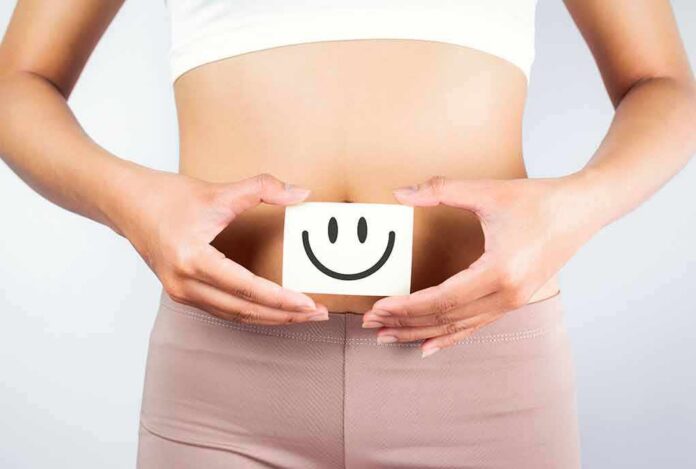 torso of person holding smiley card over stomach