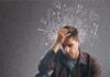 Man holding his head with chaotic doodles around his mind
