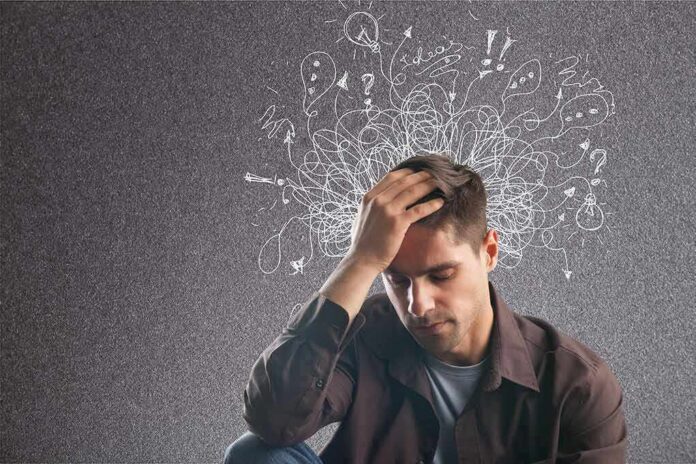 Man holding his head with chaotic doodles around his mind