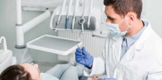 Dentist examining patient in dental chair