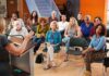 Audience listening to a speaker in a small community meeting room
