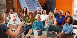 Audience listening to a speaker in a small community meeting room