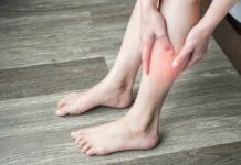 Glute Squeeze Trick Stuns Arthritis Sufferers person holding calf with red area indicating leg pain