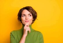 The Science Behind Gut Feelings woman in green turtleneck thinking against yellow background