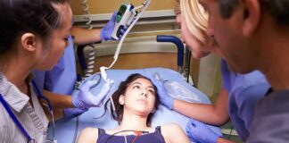 Patient on hospital gurney surrounded by medical staff