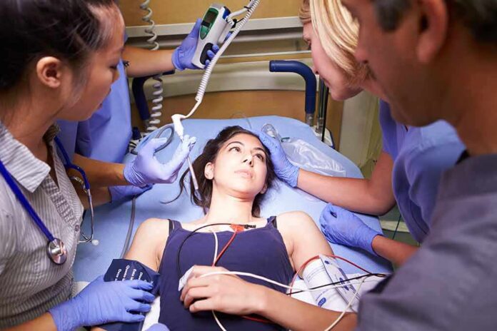 Patient on hospital gurney surrounded by medical staff
