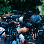 Unexpected Blood Pressure Fix On Your Plate TV news cameras crowding together at an outdoor event