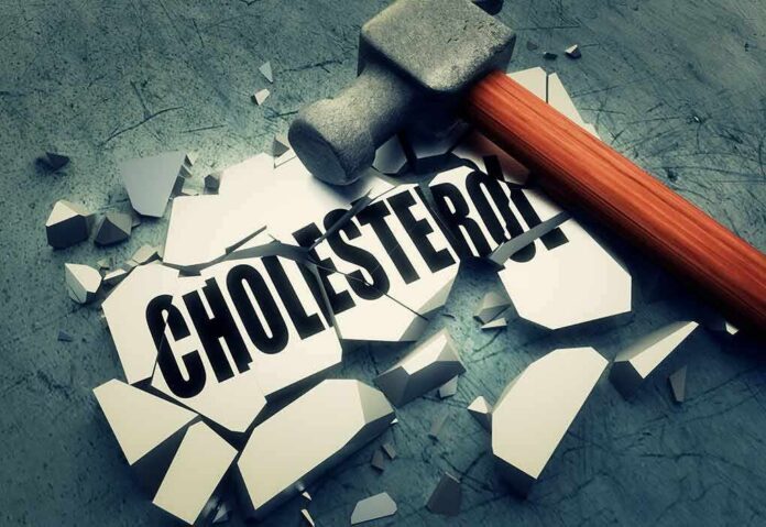 shutterstock_261771980 Sledgehammer smashing a tile labeled cholesterol