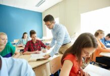 Teacher assisting students in a classroom