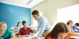 Teacher assisting students in a classroom