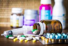 Abortion Pill Deadline Stuns Seoul Medicine pills and syringe on table with brown bottle