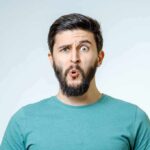 Man with beard making surprised face