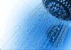 Hot Water Mistake Wrecks Senior Skin Close-up of a shower head with water droplets against a blue background