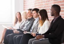 The Surprising Way Your Job History May Be Linked To Brain Health Job applicants seated in a row with clipboards