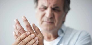 Man holding his hand in discomfort