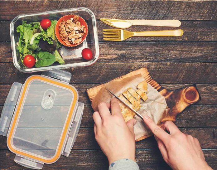1783879614277-x786a8-shutterstock-643319584 Hands slicing cooked chicken on a wooden cutting board