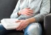 Bloating Trap: The Fiber Mistake Everyone Makes Person holding takeout container while touching stomach
