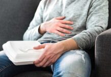 Bloating Trap: The Fiber Mistake Everyone Makes Person holding takeout container while touching stomach