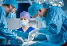 Surgeons perform an operation in a hospital operating room