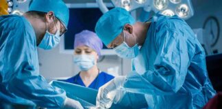 Surgeons perform an operation in a hospital operating room
