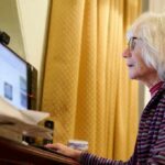 Older woman using a desktop computer at a desk