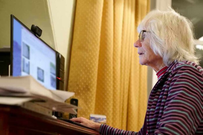 Older woman using a desktop computer at a desk