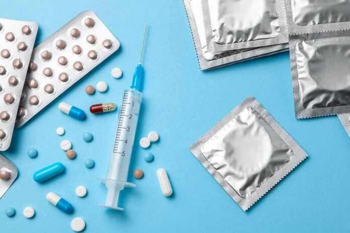 shutterstock_1266659281 Contraceptives and medications on blue background