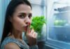 The Real Sleep Killers In Your Diet Woman shushing while standing at an open refrigerator