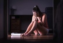 Fast Fat Loss, Hidden Muscle Cost Woman sitting on floor covering face beside a bathroom scale
