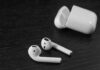 Ozlo Sleepbuds 2 Review – These Will Help You Sleep Better Wireless earbuds with open charging case on dark wood