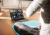 One Workout Topples Belly Fat & Waistlines person on yoga mat watching a virtual workout class on a laptop
