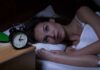 Insomnia Breakthrough: Two-Step Combo Wins Woman lying awake in bed beside an alarm clock