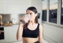 WHO Warning: Stop Chasing Protein Powders Woman in sportswear drinking a smoothie in a kitchen
