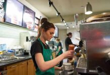 Barista preparing a drink at a coffee shop counter