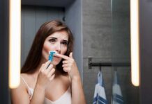 Razor Burn Mistake Wrecking Intimate Skin Woman shaving upper lip in bathroom mirror