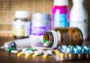 Common Pill Mimics Dementia – Doctors Worried Medicine pills and syringe on table with brown bottle