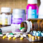 Ozempic Shock: Rare Brain Disorder Flagged Medicine pills and syringe on table with brown bottle