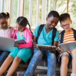 Devices Up, TV Down – Health Risk Up? Children using laptops and tablets on school steps