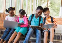Devices Up, TV Down – Health Risk Up? Children using laptops and tablets on school steps